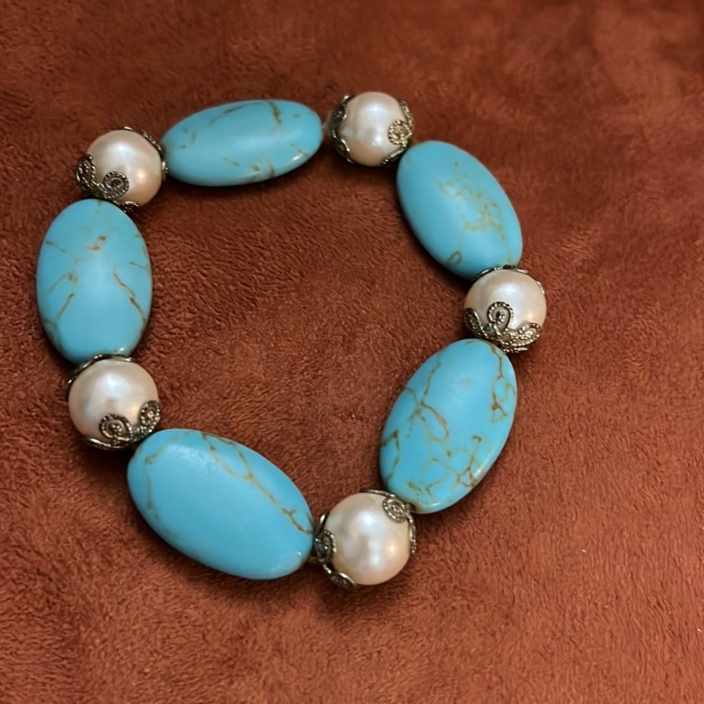 Aqua and pearl stretchy bracelet with metal on each ends of the pearl